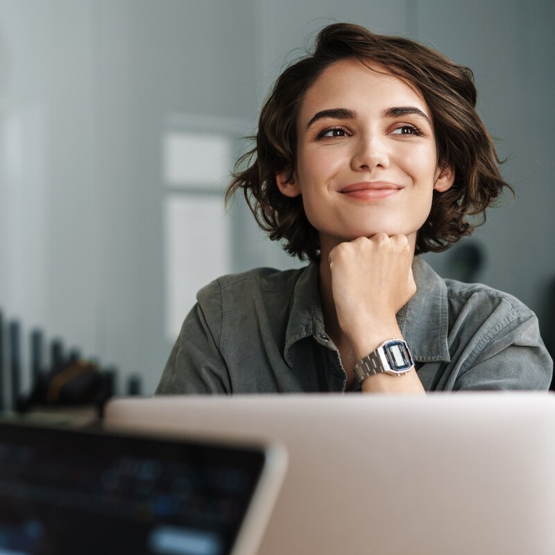 administrative professional sitting at desk and smiling